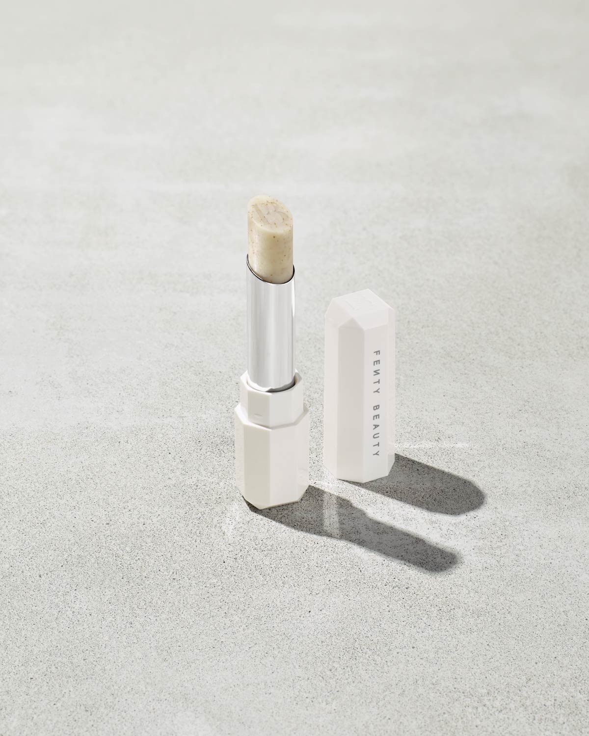 Pro Kiss'r Lip-Loving Scrubstick standing upright with the cap off and the lip scrub twisted up.