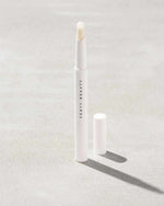 Brow MVP Sculpting Wax Pencil standing upright with the cap off and the brow wax twisted up.