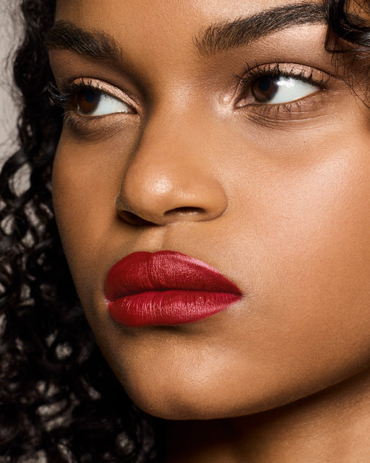medium skin toned model wearing stunna lip paint in the shade uncensored