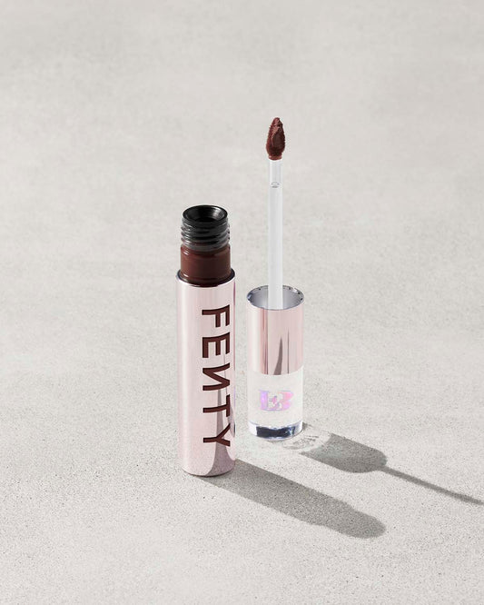 An open Fenty Icon Velvet lipstick tube on a light background.