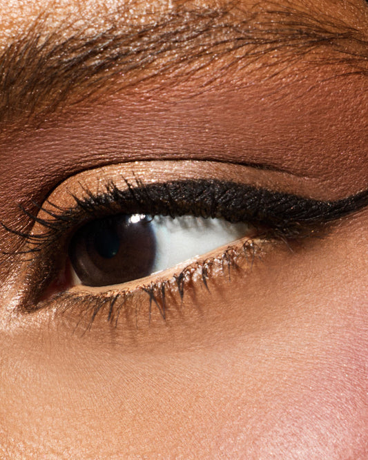 Macro of model wearing Fine Linez Lash-Enhancing Eyeliner in shade 'Cuz I'm Black'.
