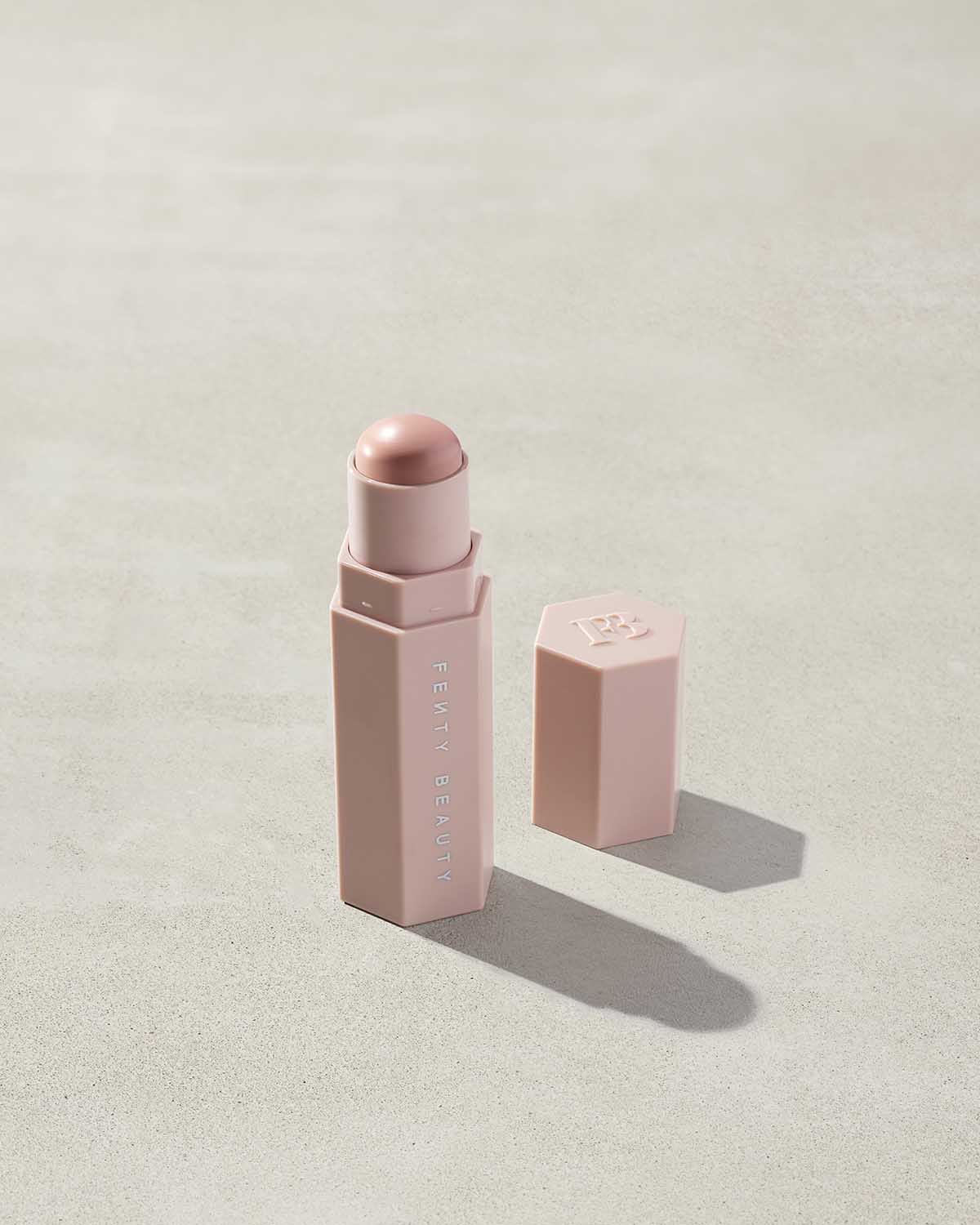 Match Stix Corrector Skinstick shown in shade Rose Quartz with open packaging on a concrete background.